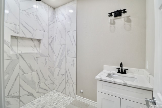 bathroom featuring vanity and tiled shower