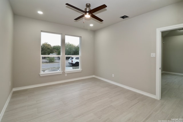 spare room featuring light wood-type flooring and ceiling fan