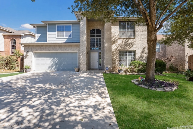 view of front of house featuring a front yard and a garage