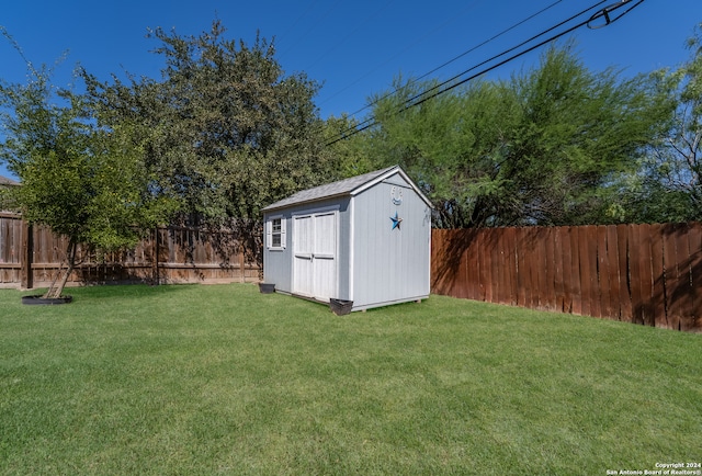 view of outdoor structure featuring a lawn