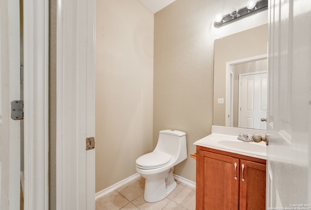 bathroom with vanity, toilet, and tile patterned flooring