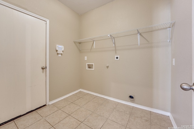 laundry area with hookup for a gas dryer, electric dryer hookup, washer hookup, and light tile patterned floors