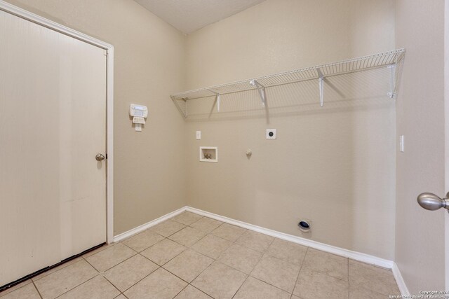 laundry area with hookup for a washing machine, electric dryer hookup, laundry area, baseboards, and hookup for a gas dryer