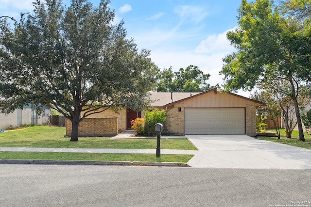 single story home with a front yard and a garage