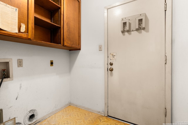 laundry room featuring hookup for a washing machine, electric dryer hookup, and cabinets