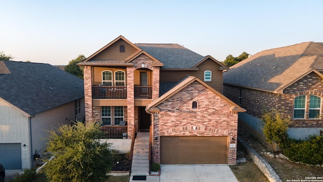 7527 Presidio Hvn, Boerne, TX 78015 - view of front facade featuring brick siding, driveway, a garage, and a balcony