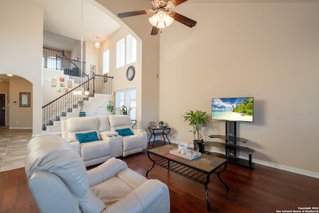7527 Presidio Hvn, Boerne, TX 78015 - living room with a high ceiling, arched walkways, baseboards, stairs, and ceiling fan