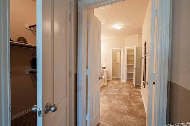7527 Presidio Hvn, Boerne, TX 78015 - bathroom featuring baseboards, visible vents, and a walk in closet