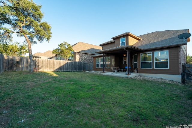 back of property with a patio and a yard