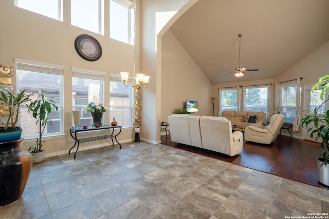 living room with high vaulted ceiling, light wood-type flooring, and ceiling fan with notable chandelier