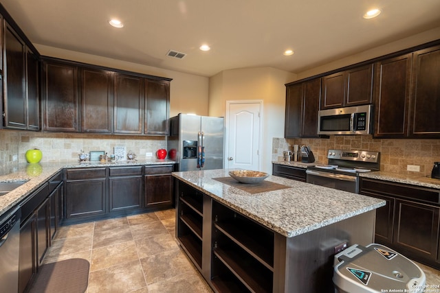 7527 Presidio Hvn, Boerne, TX 78015 - kitchen with recessed lighting, open shelves, dark brown cabinetry, and stainless steel appliances