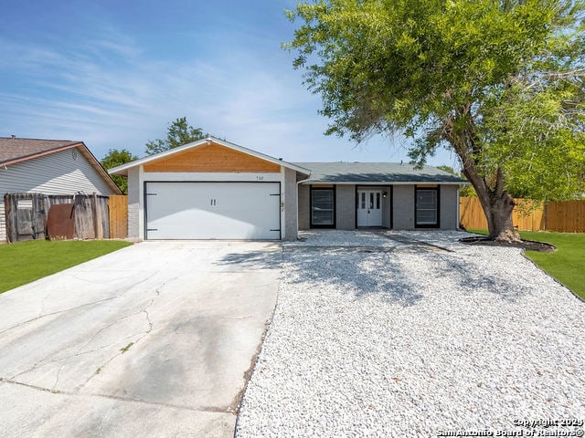 ranch-style home with a front lawn and a garage