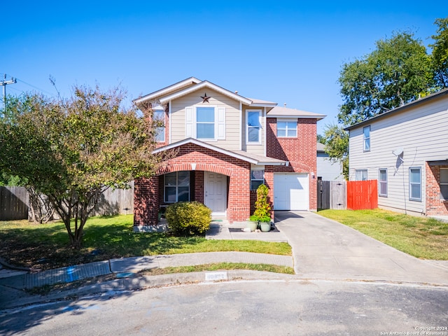 view of front of home with a front yard and a garage