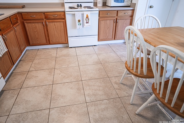 kitchen with white appliances and light tile patterned floors