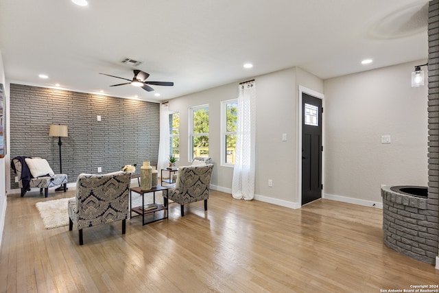 living room with light hardwood / wood-style flooring and ceiling fan