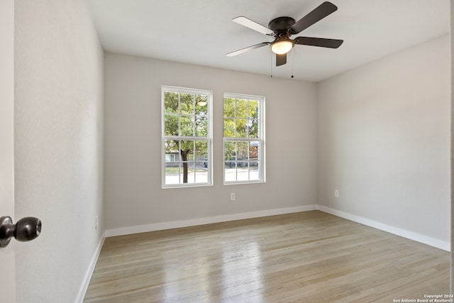 spare room featuring light hardwood / wood-style floors and ceiling fan