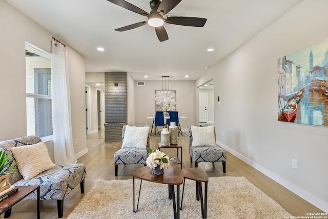 living area featuring light hardwood / wood-style flooring and ceiling fan