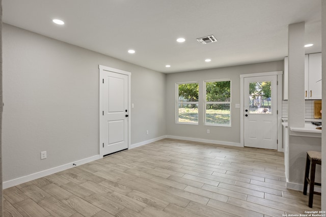 unfurnished living room featuring light hardwood / wood-style floors