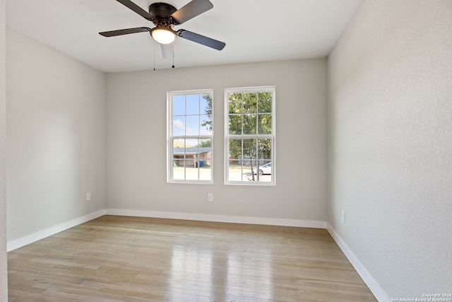 unfurnished room with light wood-type flooring and ceiling fan