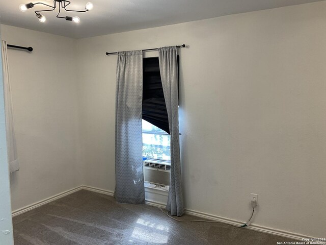 4543 Guadalajara Dr, San Antonio, TX 78233 - carpeted empty room with baseboards, cooling unit, and a chandelier