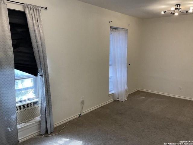 4543 Guadalajara Dr, San Antonio, TX 78233 - spare room with baseboards, a notable chandelier, dark carpet, and cooling unit