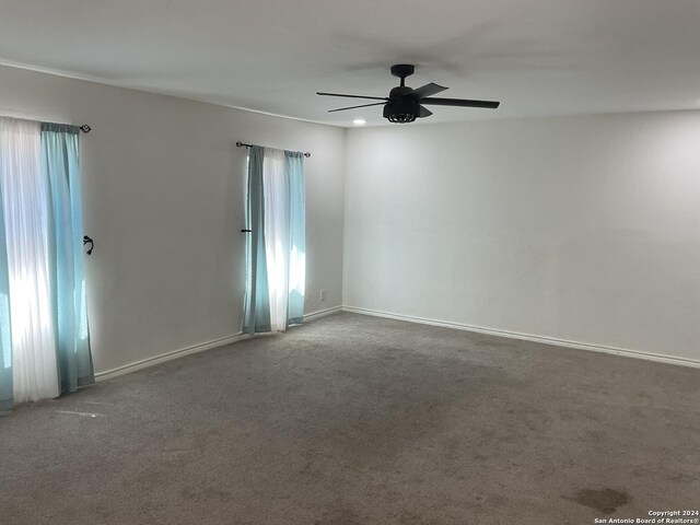 4543 Guadalajara Dr, San Antonio, TX 78233 - carpeted empty room featuring baseboards, a ceiling fan, and a healthy amount of sunlight