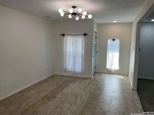 4543 Guadalajara Dr, San Antonio, TX 78233 - spare room with baseboards, visible vents, tile patterned floors, and a chandelier