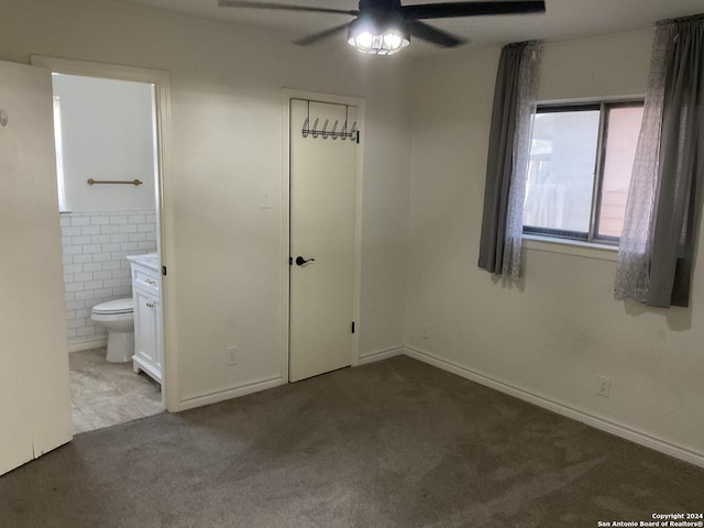 4543 Guadalajara Dr, San Antonio, TX 78233 - unfurnished bedroom with ceiling fan, carpet floors, ensuite bathroom, and tile walls