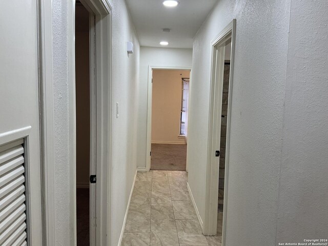 4543 Guadalajara Dr, San Antonio, TX 78233 - hallway with recessed lighting, a textured wall, baseboards, and marble finish floor