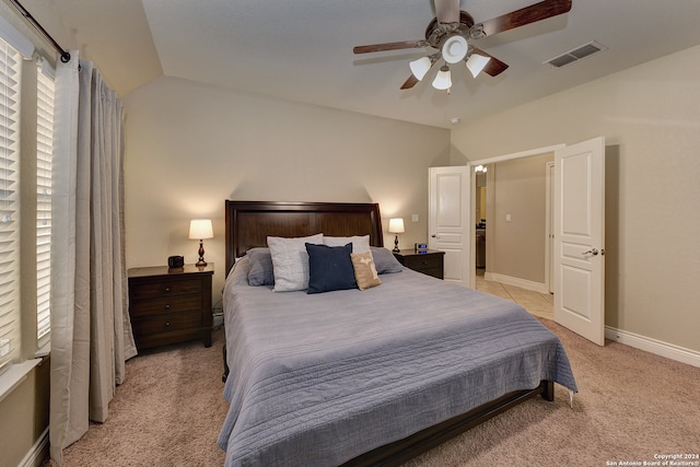 carpeted bedroom with ceiling fan and lofted ceiling