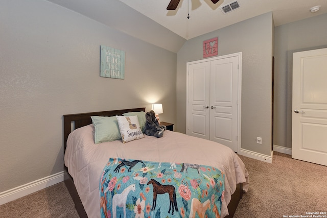 bedroom featuring a closet, ceiling fan, carpet, and vaulted ceiling