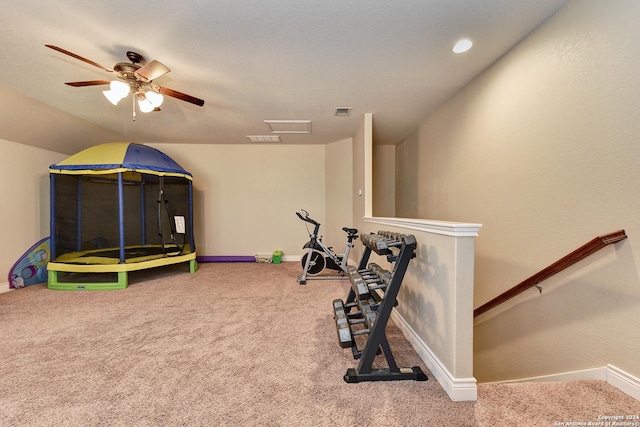 exercise area with ceiling fan and carpet floors