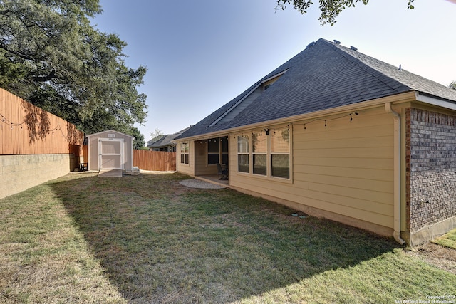 rear view of property featuring a shed and a lawn