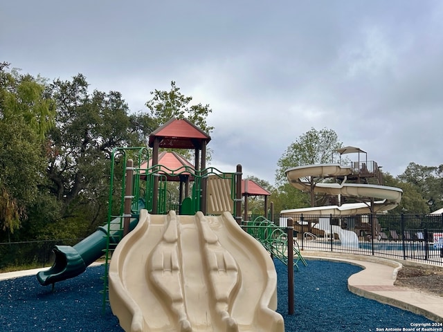 view of jungle gym with a community pool