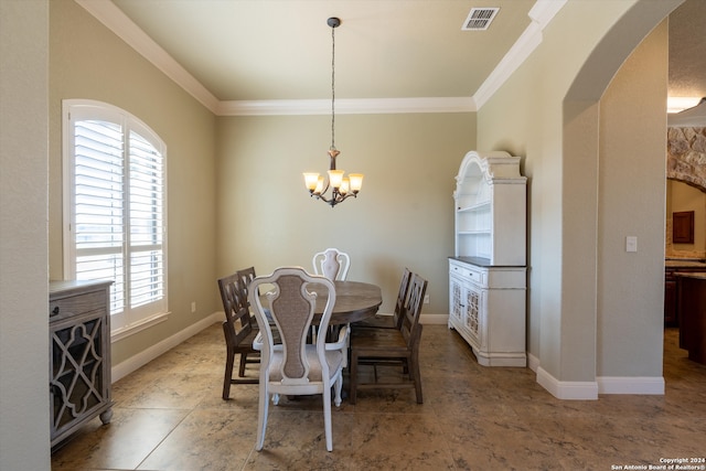 dining area with crown molding and a notable chandelier