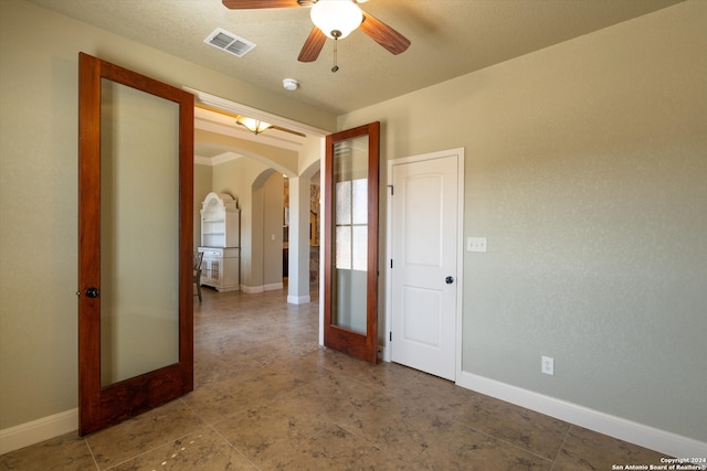 spare room with french doors and ceiling fan