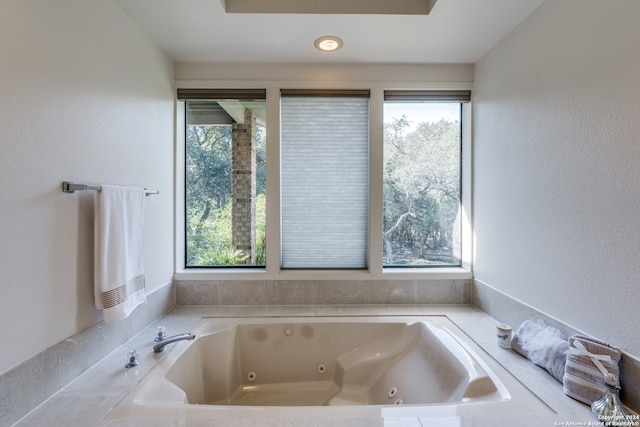 bathroom featuring a tub to relax in and plenty of natural light