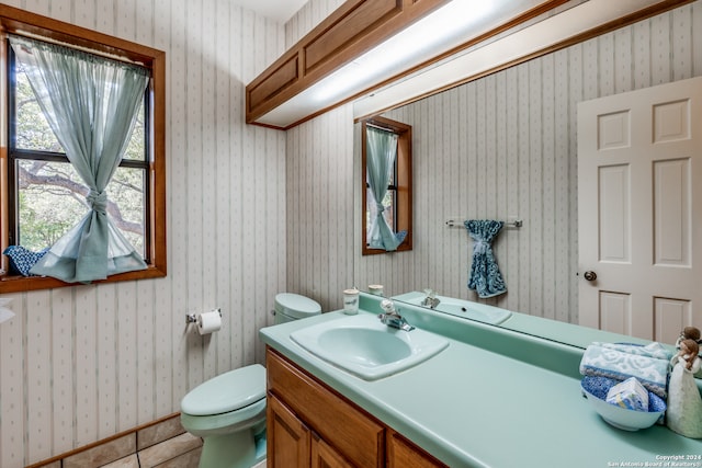 bathroom featuring vanity, toilet, and tile patterned floors