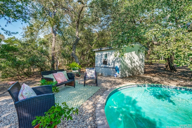 view of swimming pool featuring a patio area and an outdoor structure