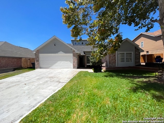 view of front of house with a front yard and a garage