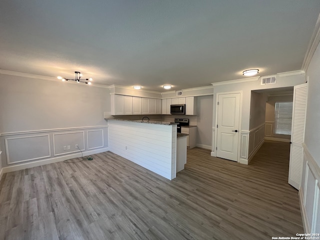 kitchen featuring white cabinets, kitchen peninsula, stainless steel appliances, and light hardwood / wood-style floors