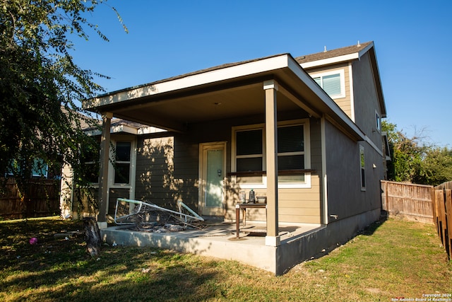 rear view of house with a yard and a patio area