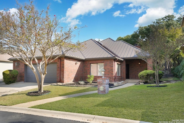 ranch-style house featuring a standing seam roof, brick siding, and concrete driveway