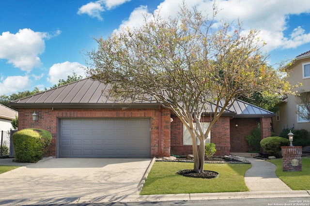 view of front of property featuring a garage and a front lawn