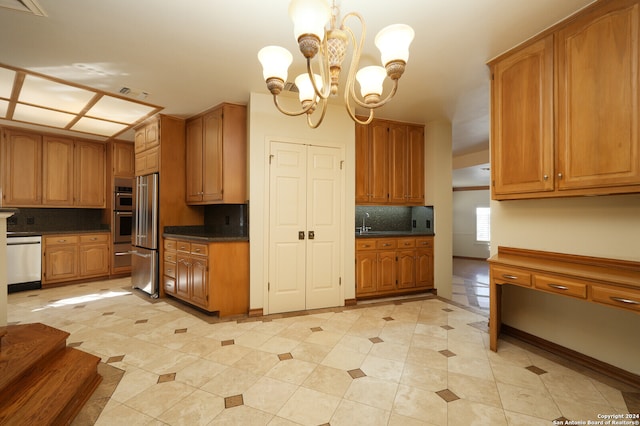 kitchen featuring backsplash, light tile patterned flooring, stainless steel appliances, a notable chandelier, and decorative light fixtures