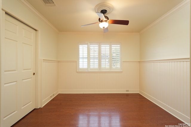 unfurnished room with ornamental molding, dark hardwood / wood-style floors, and ceiling fan