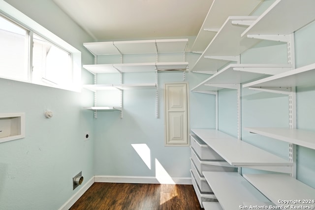 washroom featuring hookup for an electric dryer and dark wood-type flooring