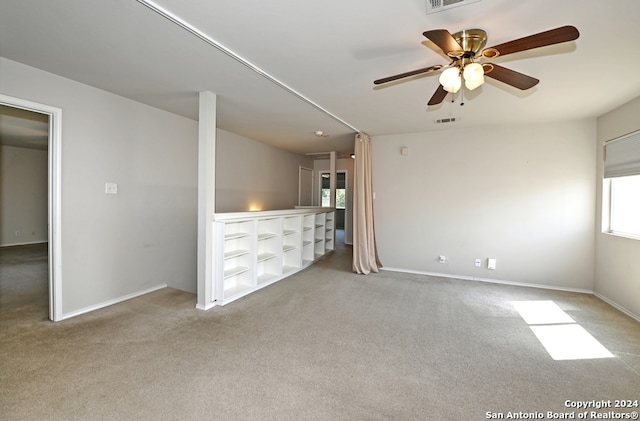 unfurnished bedroom featuring light colored carpet and ceiling fan