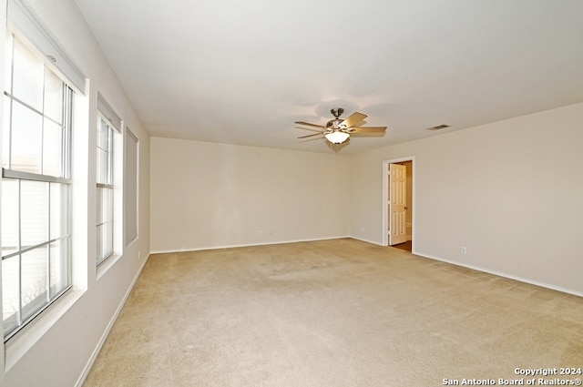 carpeted empty room with ceiling fan