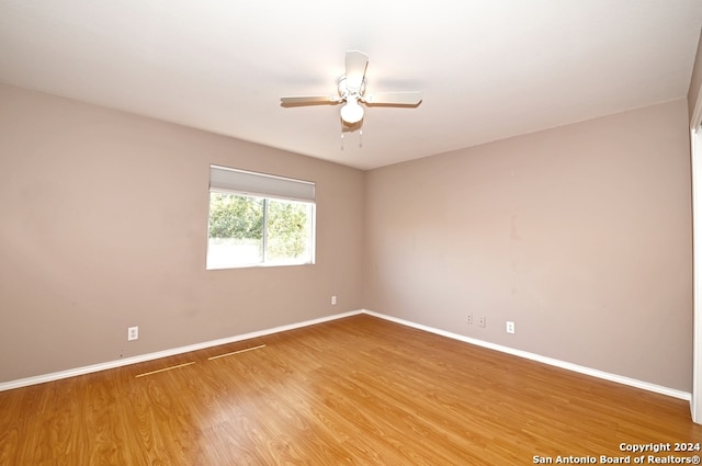 unfurnished room featuring hardwood / wood-style floors and ceiling fan